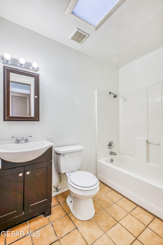 full bathroom featuring bathtub / shower combination, a skylight, toilet, tile patterned floors, and vanity