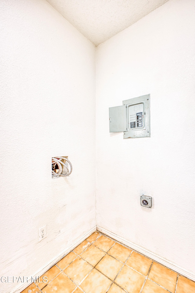 laundry room featuring tile patterned floors and a textured ceiling