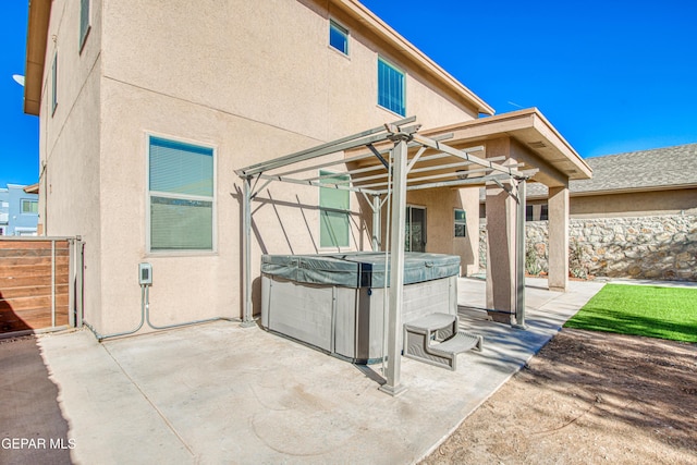 view of patio / terrace featuring a pergola and a hot tub