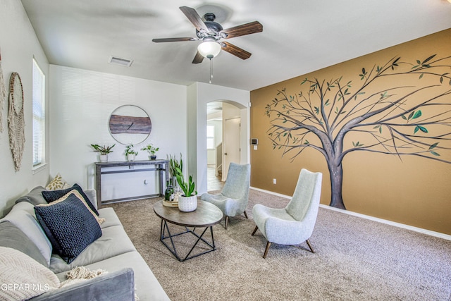 carpeted living room featuring ceiling fan