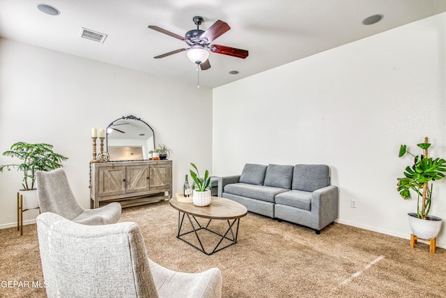 carpeted living room with ceiling fan