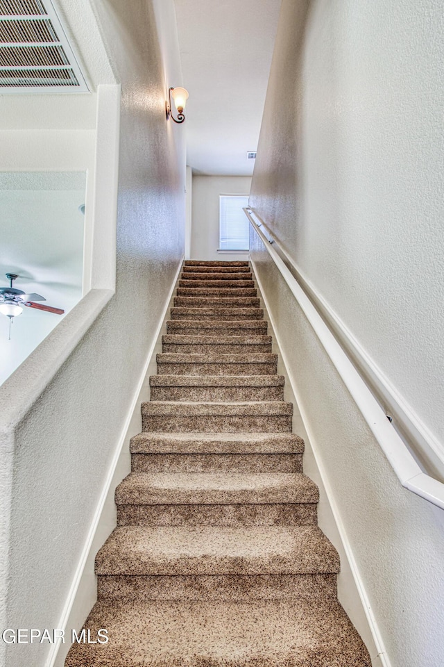 stairs with ceiling fan