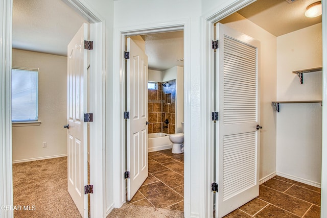 hall with a textured ceiling