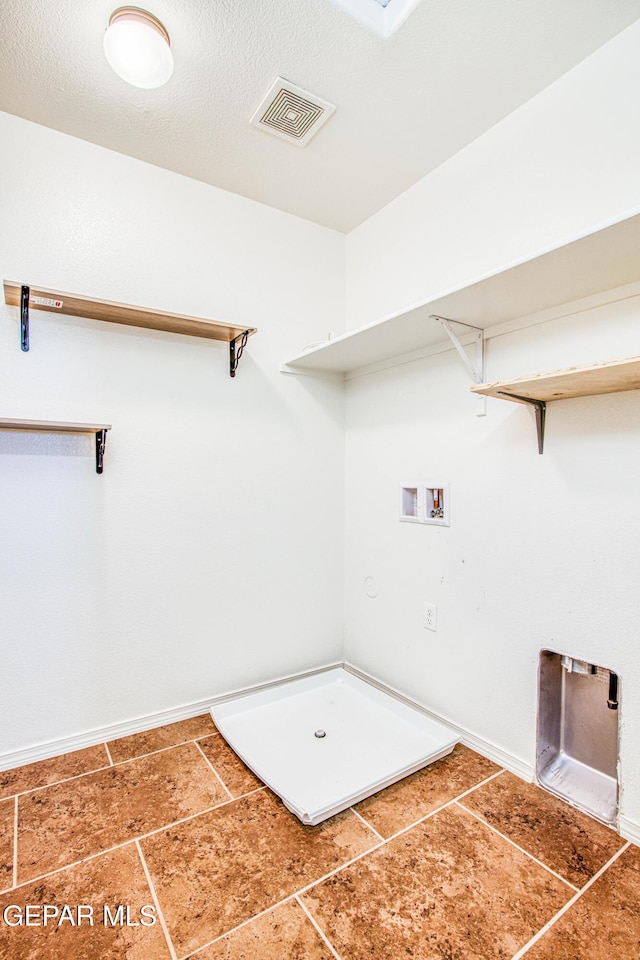 clothes washing area featuring tile patterned floors and washer hookup