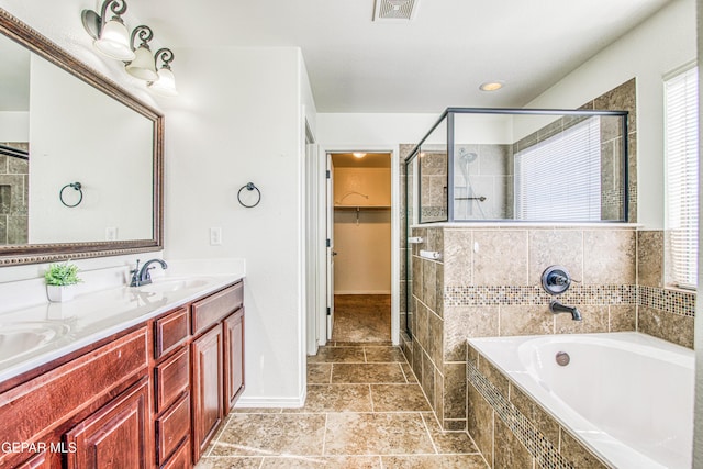 bathroom with vanity and separate shower and tub