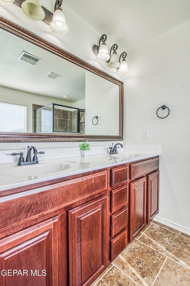 bathroom with vanity and an enclosed shower