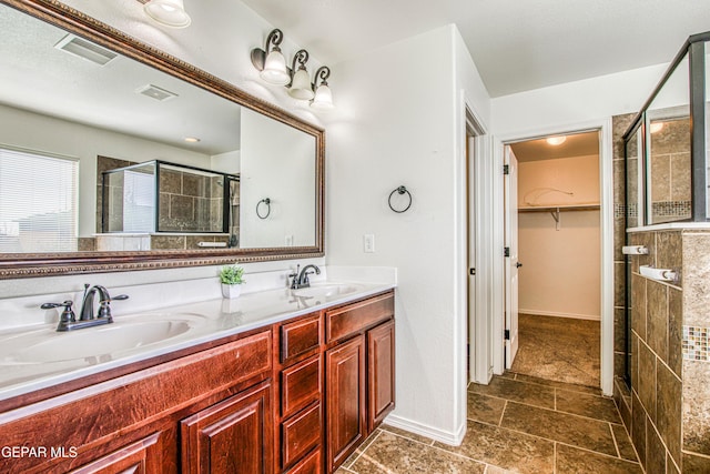 bathroom with vanity and a shower with shower door