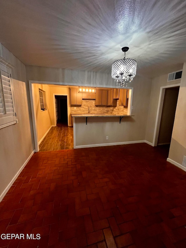 unfurnished living room with an inviting chandelier