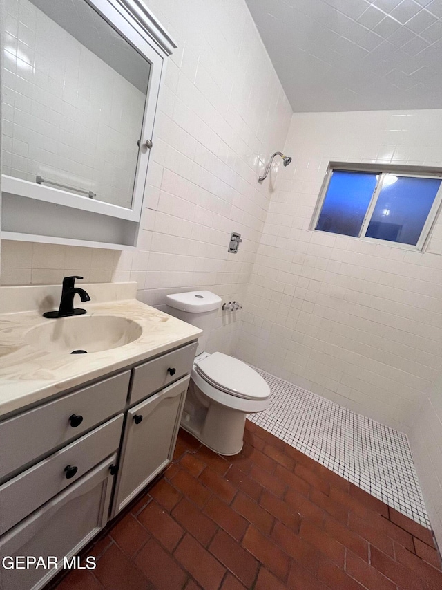 bathroom featuring tasteful backsplash, tile walls, vanity, tiled shower, and toilet