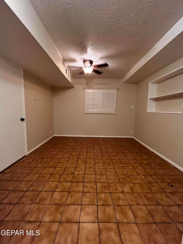 interior space with a textured ceiling and built in shelves