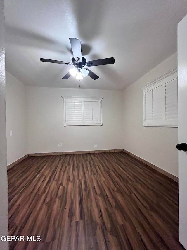 unfurnished room featuring dark hardwood / wood-style flooring and ceiling fan