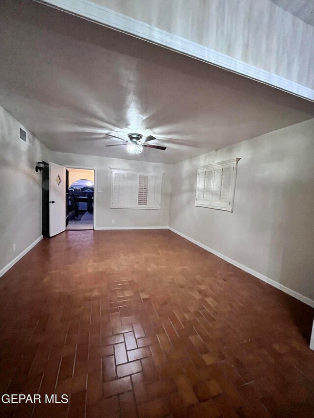 unfurnished living room with ceiling fan