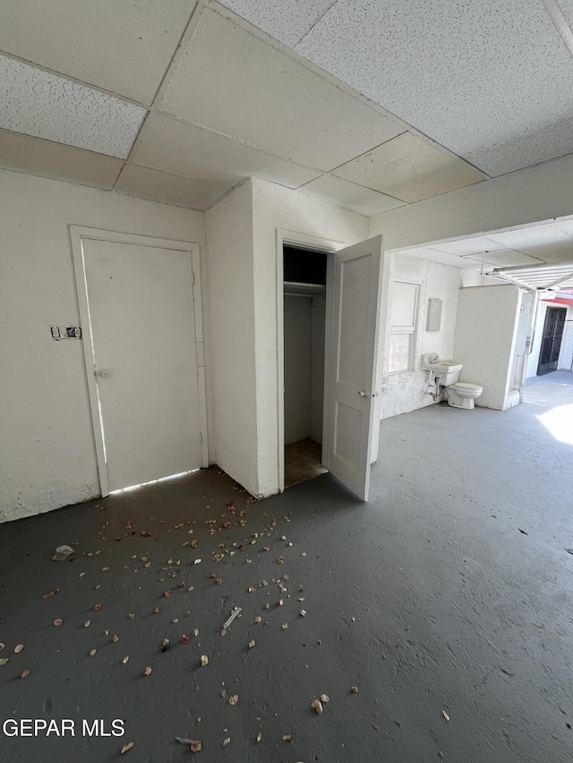 unfurnished bedroom featuring a paneled ceiling and a closet