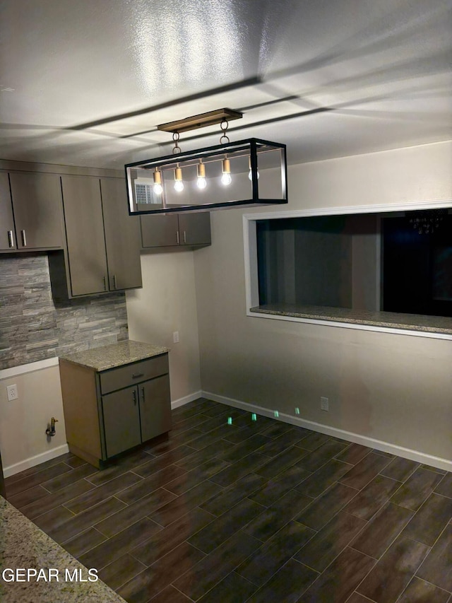 kitchen with backsplash and light stone countertops