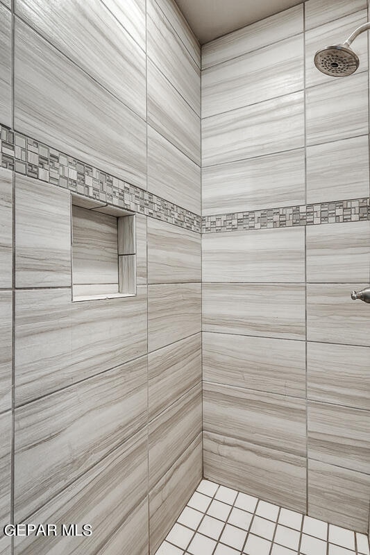 bathroom with a tile shower