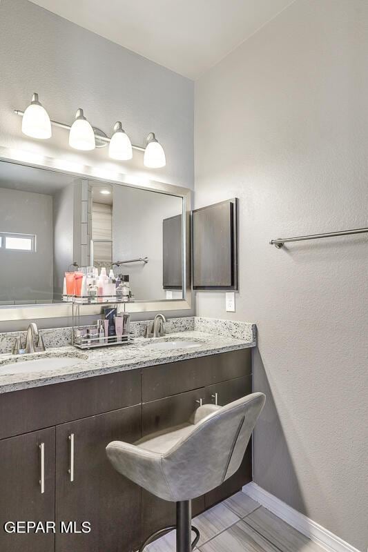 14805 Sam Garcia Ave, El Paso, TX 79938 - full bath featuring baseboards and double vanity