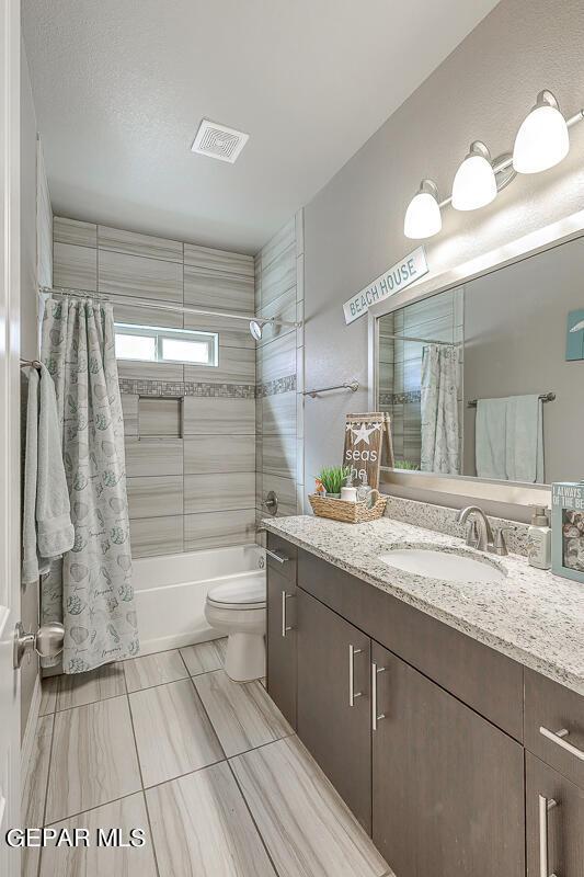 14805 Sam Garcia Ave, El Paso, TX 79938 - full bath featuring toilet, shower / bath combination with curtain, and vanity