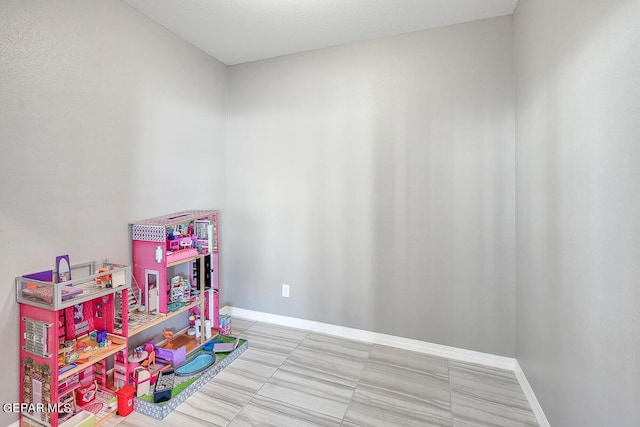 14805 Sam Garcia Ave, El Paso, TX 79938 - rec room with baseboards and tile patterned floors