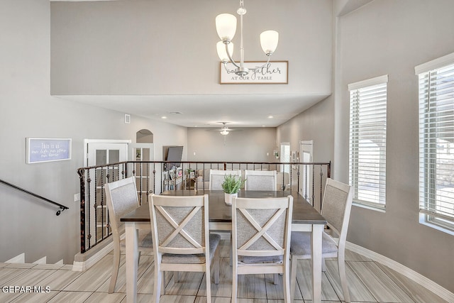 dining room with ceiling fan with notable chandelier