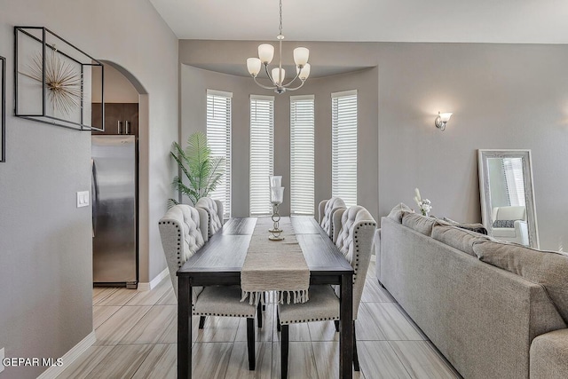 14805 Sam Garcia Ave, El Paso, TX 79938 - dining area with a chandelier, arched walkways, and baseboards