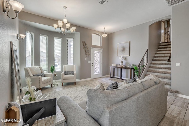 14805 Sam Garcia Ave, El Paso, TX 79938 - living room featuring healthy amount of natural light, arched walkways, baseboards, and a chandelier