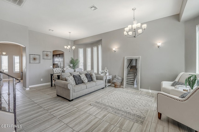 living room featuring a chandelier and plenty of natural light