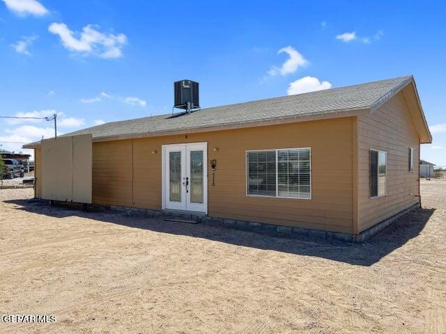 rear view of house featuring french doors and central AC