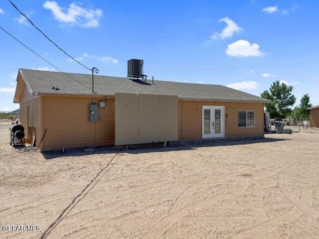 rear view of property with french doors and cooling unit