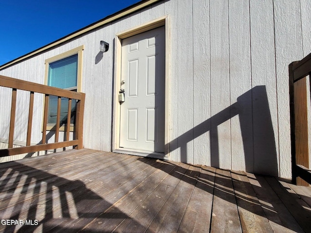 view of exterior entry featuring a deck