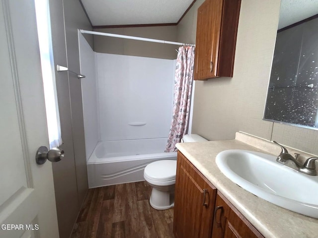 full bathroom featuring toilet, hardwood / wood-style floors, vanity, a textured ceiling, and shower / bathtub combination with curtain