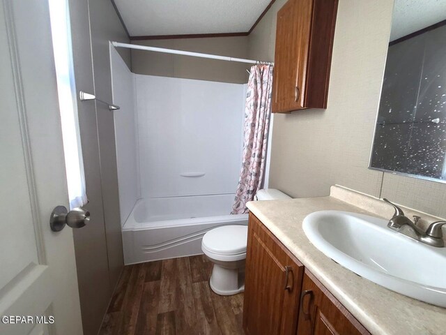 bathroom with vanity, shower / tub combo with curtain, crown molding, wood finished floors, and toilet
