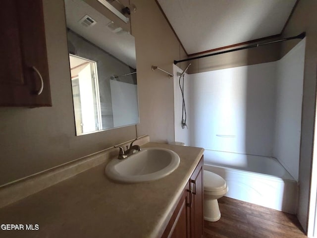 full bathroom with visible vents, vaulted ceiling, vanity, toilet, and tub / shower combination