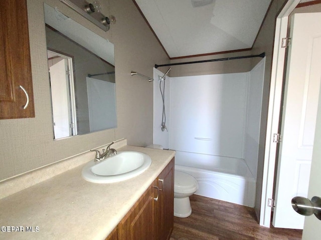 full bathroom with lofted ceiling, hardwood / wood-style floors,  shower combination, toilet, and vanity