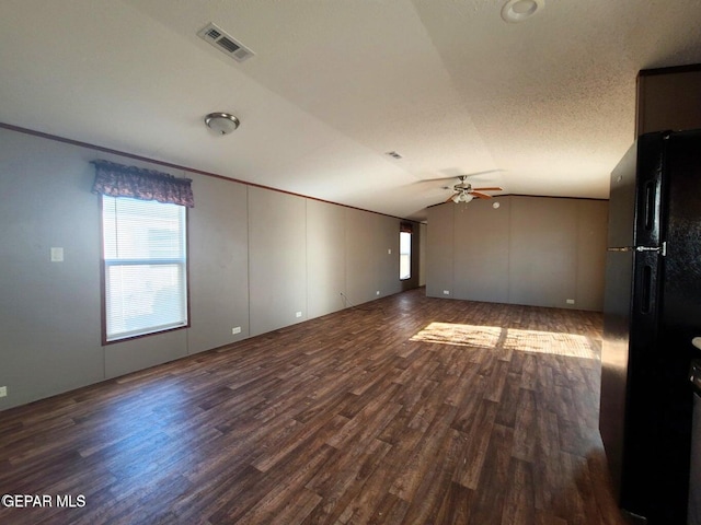 unfurnished room featuring visible vents, a ceiling fan, lofted ceiling, and wood finished floors