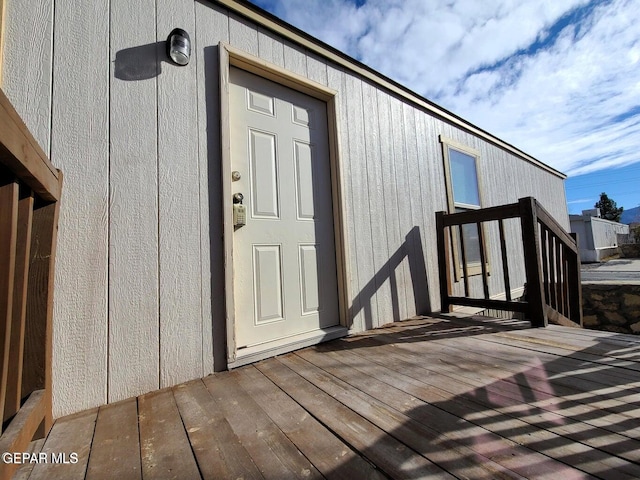 view of exterior entry featuring a deck