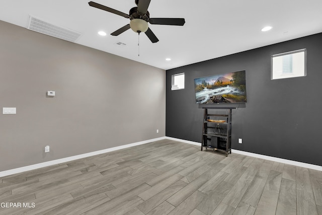 empty room with light hardwood / wood-style flooring and ceiling fan