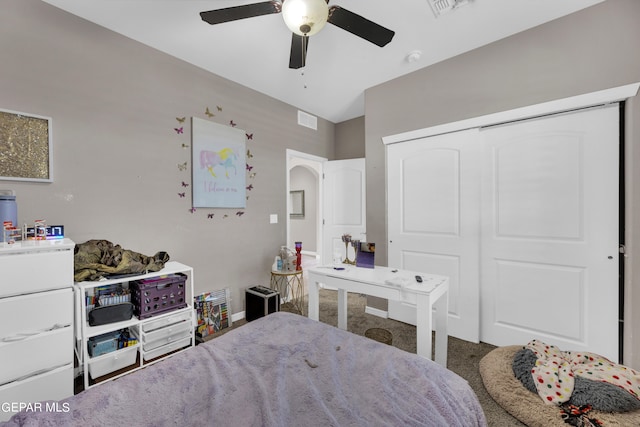 carpeted bedroom with a closet and ceiling fan