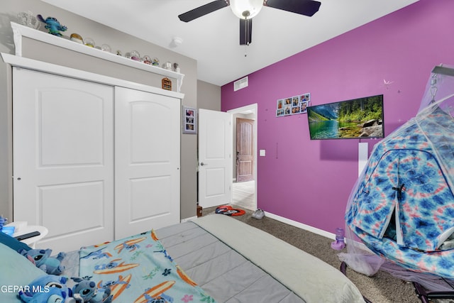 carpeted bedroom featuring a closet and ceiling fan