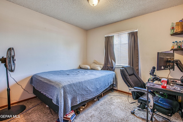 bedroom with carpet and a textured ceiling