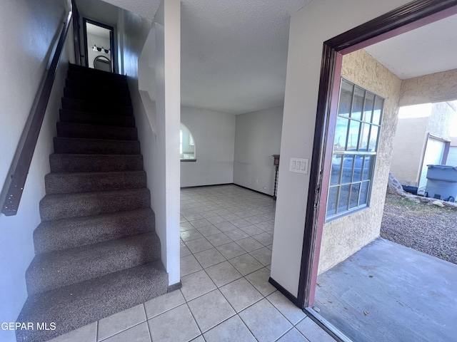 stairway featuring tile patterned flooring