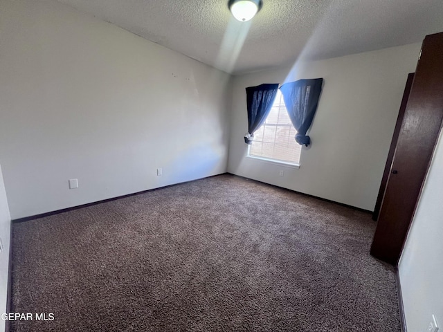 unfurnished room featuring carpet floors and a textured ceiling