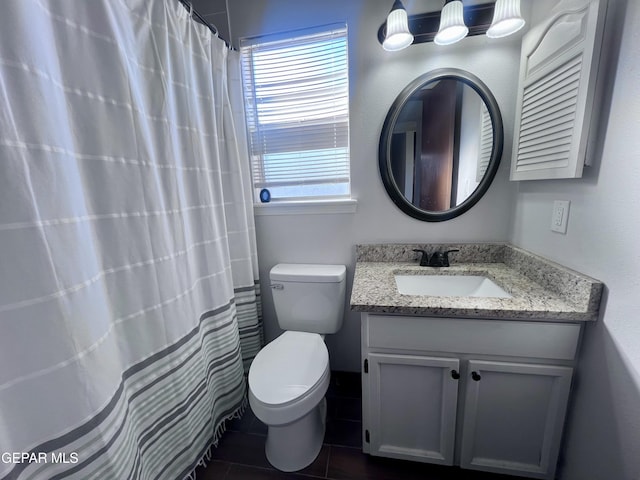 bathroom featuring tile patterned floors, vanity, toilet, and a shower with shower curtain