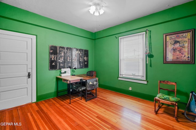 office space featuring ceiling fan and hardwood / wood-style flooring