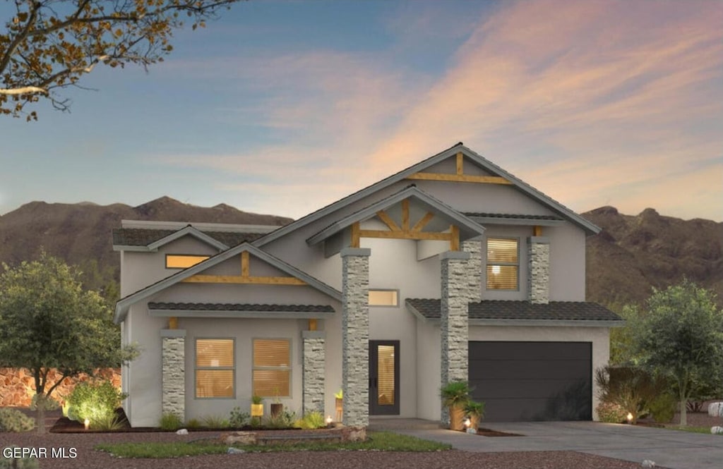 view of front of property featuring a mountain view and a garage