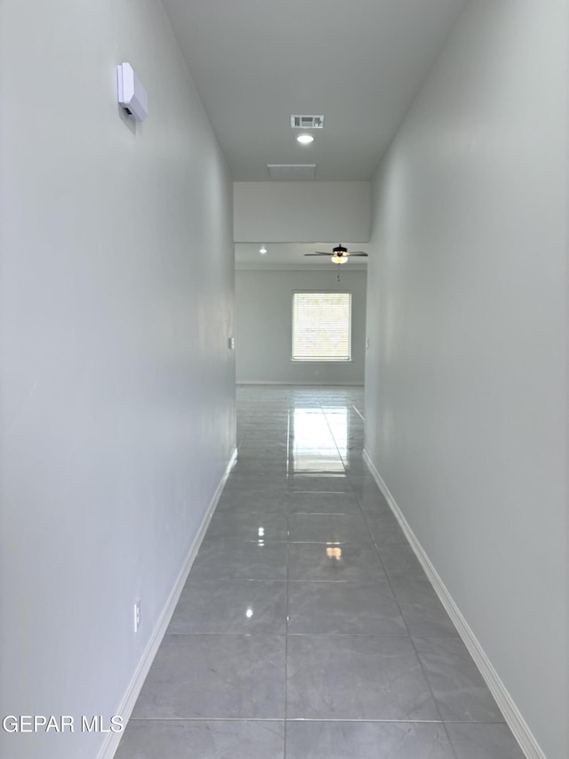 corridor featuring visible vents and baseboards