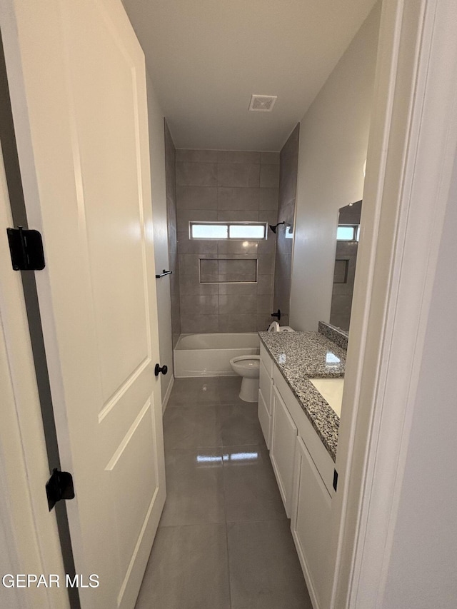 full bathroom featuring vanity, visible vents, tile patterned flooring, shower / bathing tub combination, and toilet