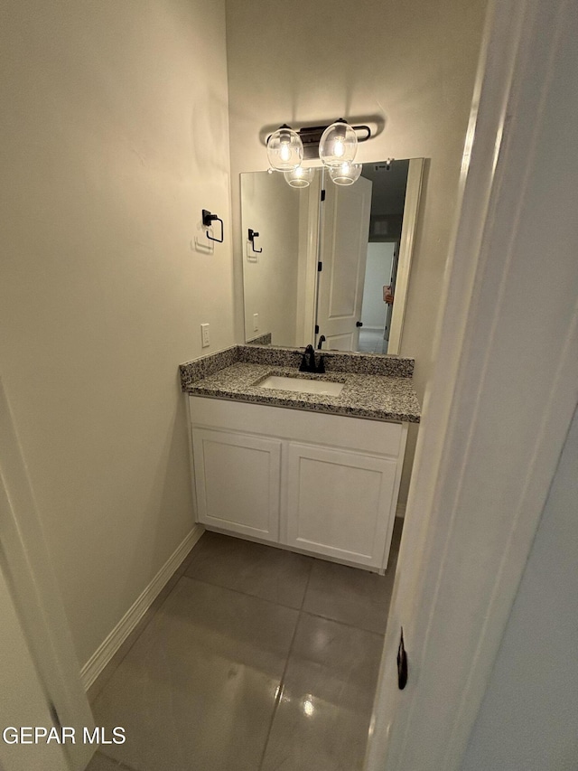 bathroom featuring baseboards, vanity, and tile patterned flooring