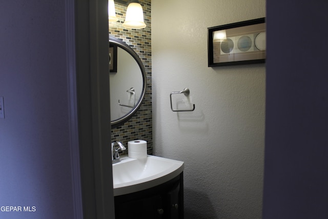 bathroom featuring vanity and decorative backsplash