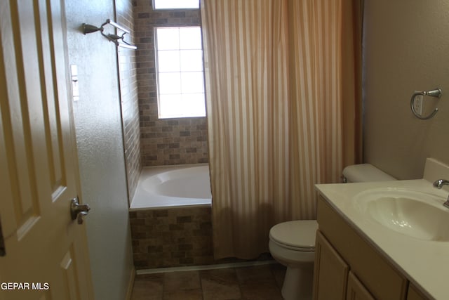 bathroom with vanity, toilet, tile patterned floors, and tiled tub