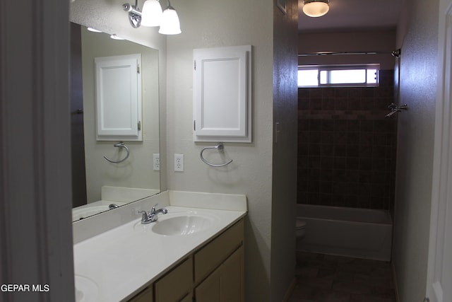 full bathroom with toilet, tiled shower / bath, vanity, and tile patterned floors